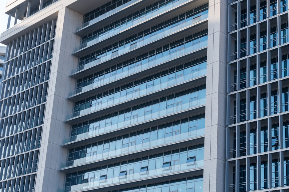 Close-up view of a modern skyscraper's glass facade with reflections, highlighting urban architecture.